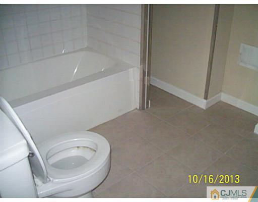 243 Walnut Street Dunellen, NJ 08812 - Photo 10 of 18 a bathroom with a toilet and a bathtub