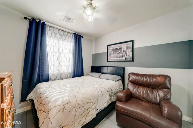 a bedroom with a bed couch and window