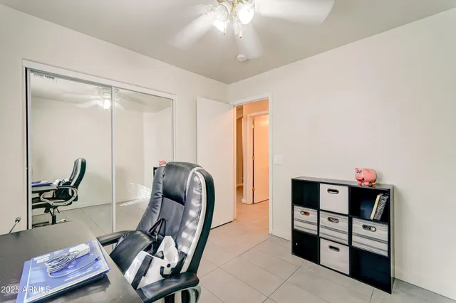 a view of a workspace with furniture and gym equipment