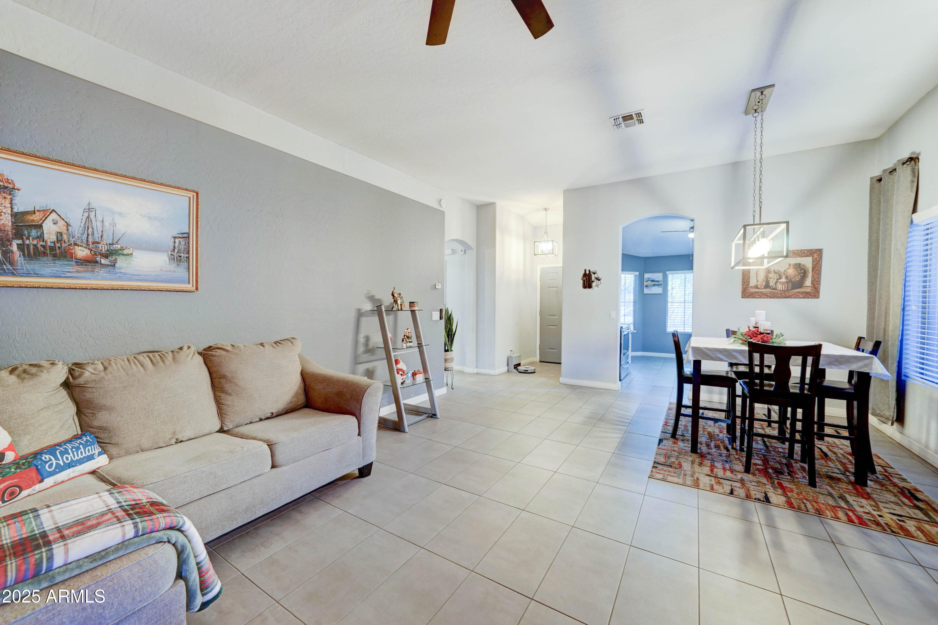 5515 South 15th Way Phoenix, AZ 85040 - Photo 6 of 26 a living room with furniture and a dining table with bookshelf