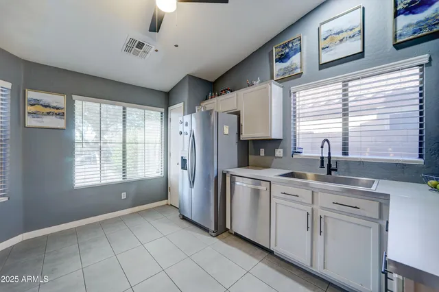 a kitchen with stainless steel appliances granite countertop a refrigerator and a sink