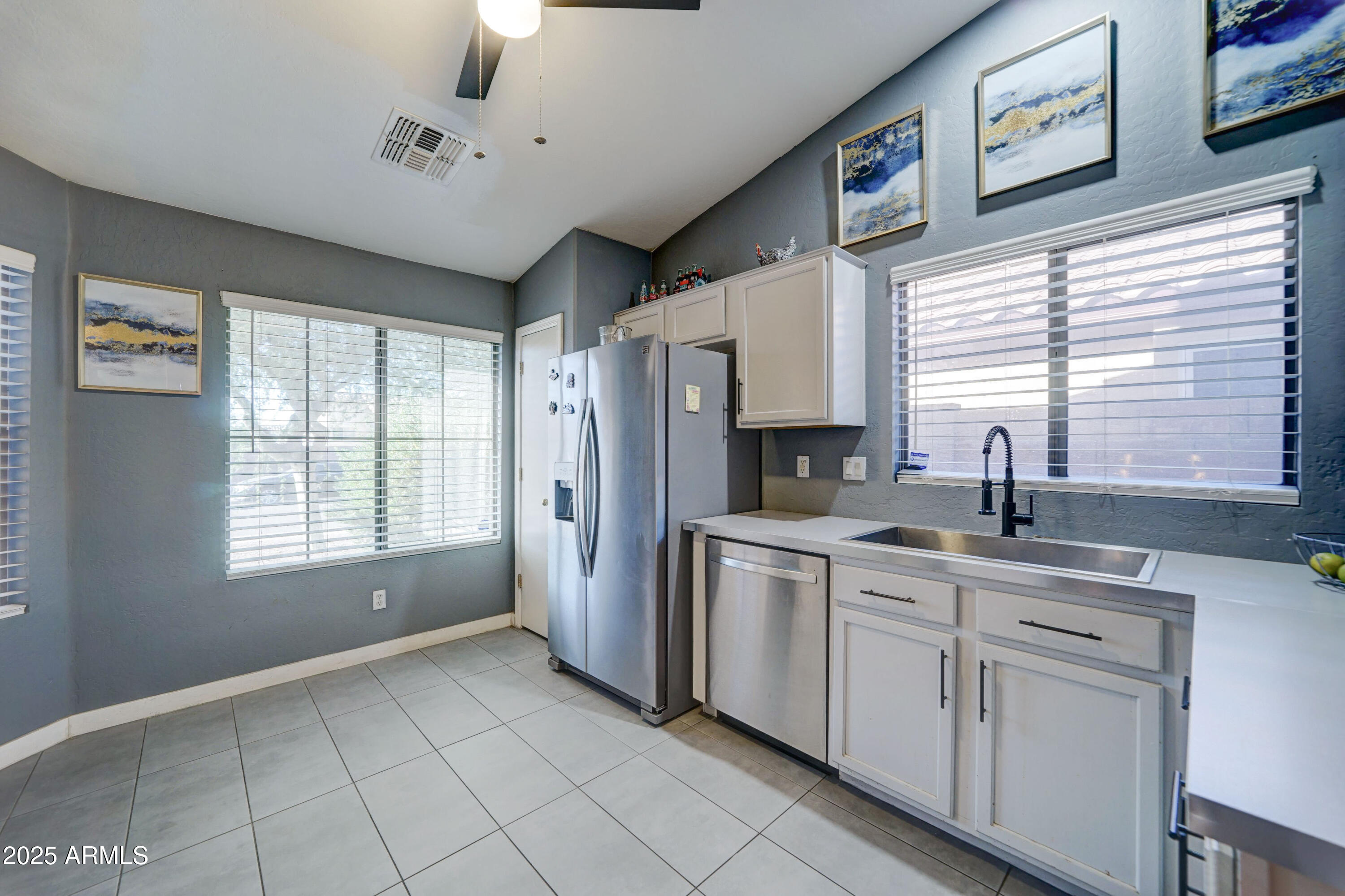 5515 South 15th Way Phoenix, AZ 85040 - Photo 8 of 26 a kitchen with stainless steel appliances granite countertop a refrigerator and a sink