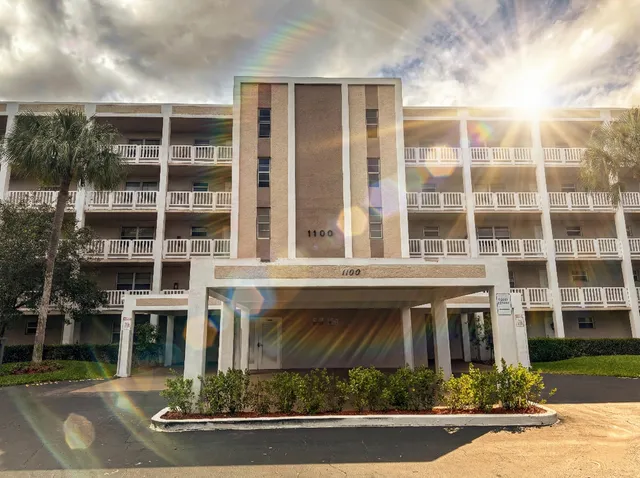 a front view of a building with a garden