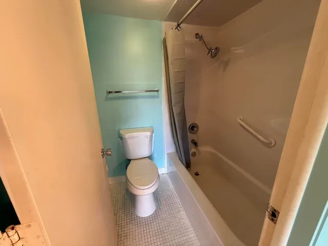 a bathroom with a toilet and a shower