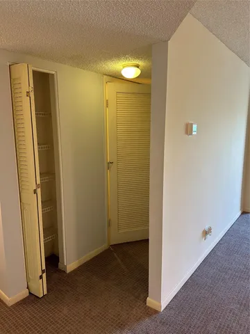 an empty room with wooden floor and entrance