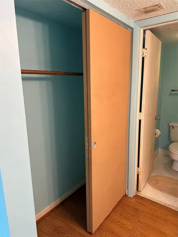 a view of a room with wooden floor