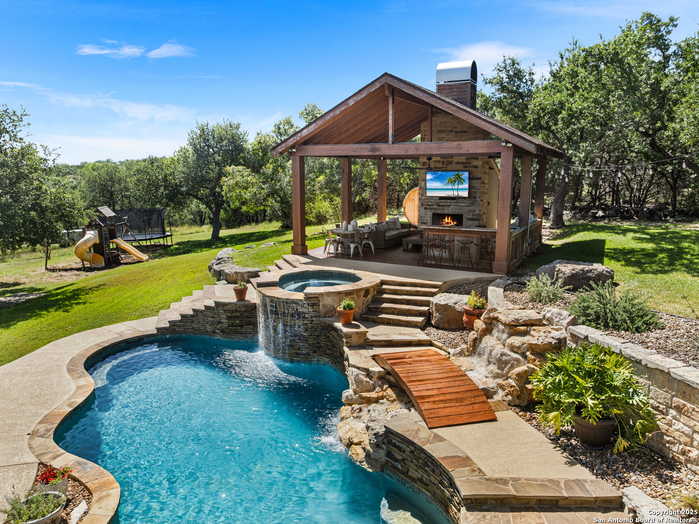 875 Shepherds Ranch Bulverde, TX 78163 - Photo 2 of 54 a view of a patio with chair and tables back yard of the house