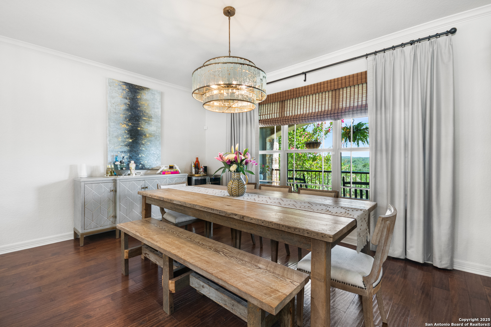 875 Shepherds Ranch Bulverde, TX 78163 - Photo 25 of 54 a dining room with wooden floor a chandelier a wooden table and chairs