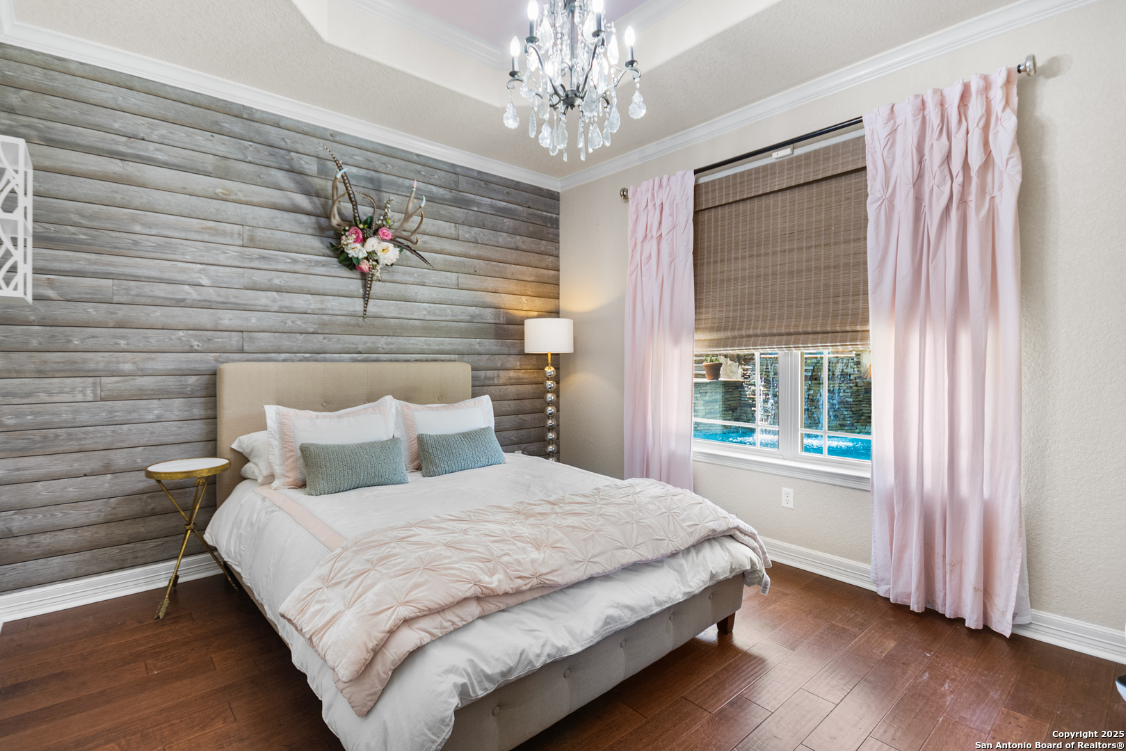 875 Shepherds Ranch Bulverde, TX 78163 - Photo 34 of 54 a bedroom with a bed and a chandelier