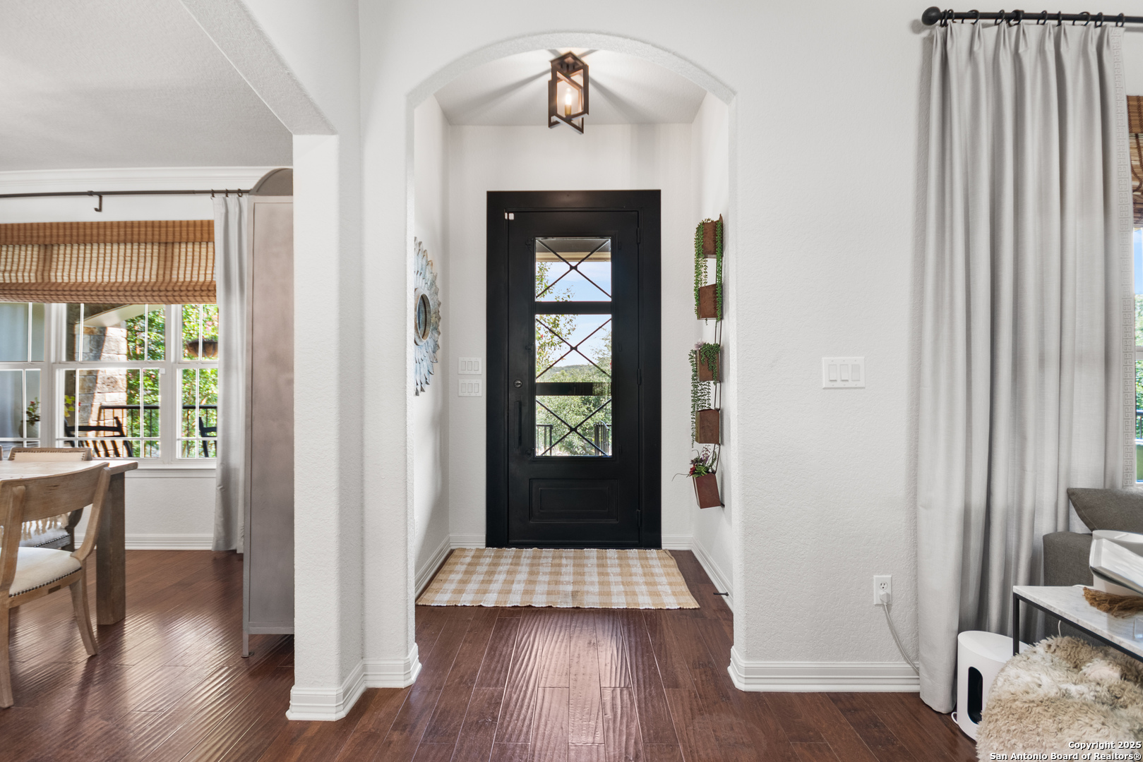 875 Shepherds Ranch Bulverde, TX 78163 - Photo 10 of 54 a view of a hallway with wooden floor and dining room