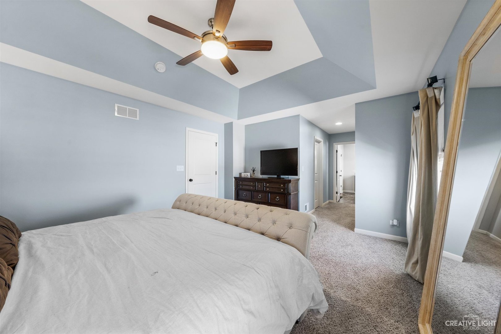 3806 Monterey Circle Algonquin, IL 60102 - Photo 16 of 33 a bedroom with a large bed a flat tv screen and a walk in closet