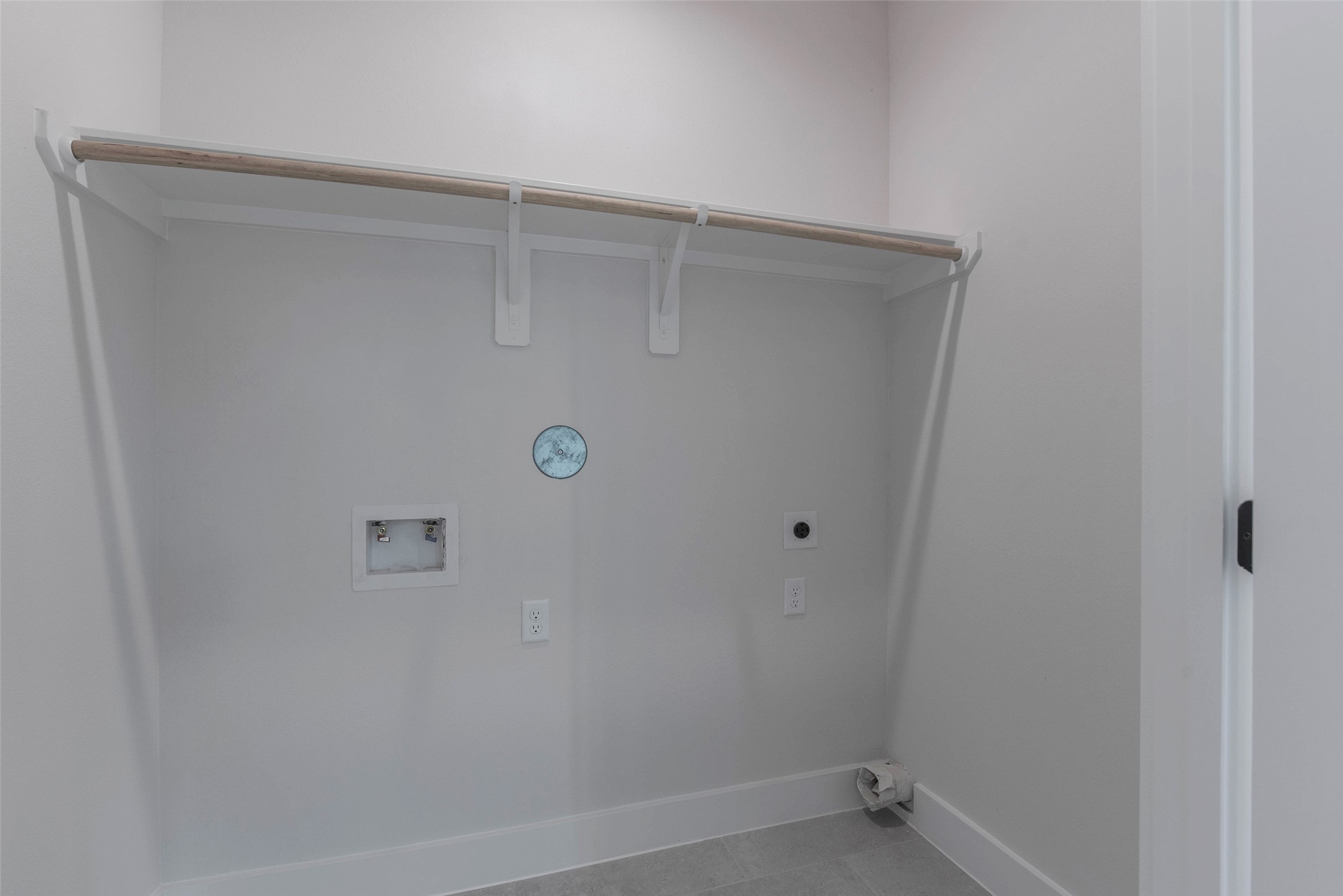 9311 Jutland Road Houston, TX 77033 - Photo 23 of 28 A spacious utility closet located off the flex space, offering ample storage for household essentials and a dedicated washer and dryer area for added convenience.