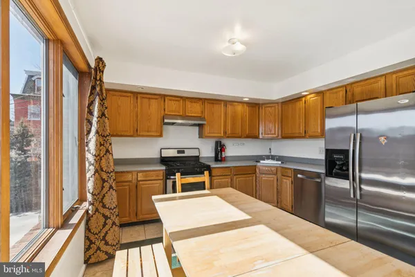 a kitchen with a stove a sink and a refrigerator