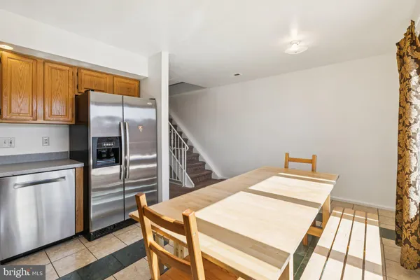 a view of a house with a backyard and wooden fence