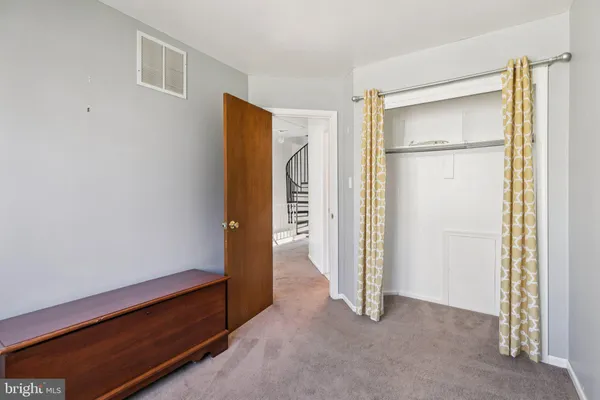 an empty room with a bathroom and a glass door