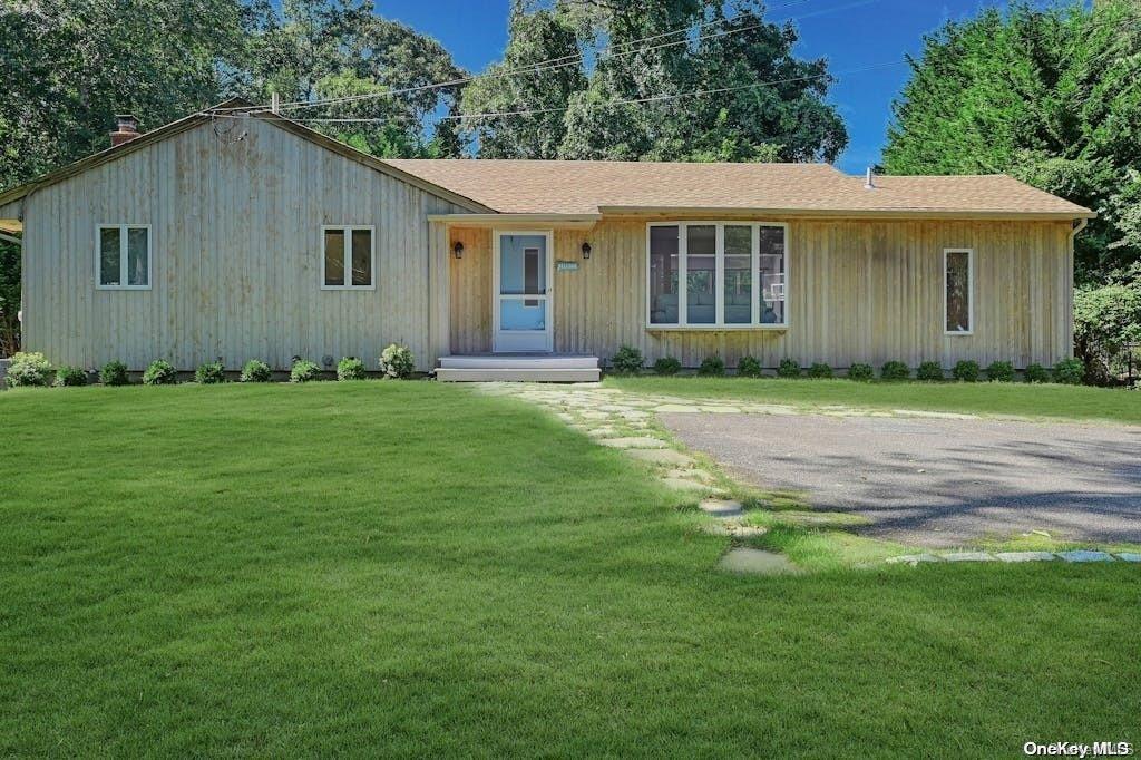 88 Rutland Road East Hampton, NY 11937 - Photo 1 of 1 a front view of a house with a garden