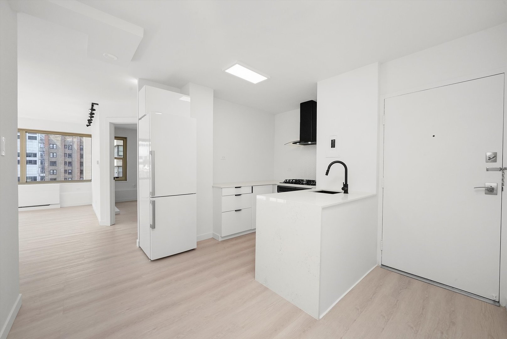247 East Chestnut Street, Unit 2004 Chicago, IL 60611 - Photo 12 of 16 a view of kitchen with refrigerator and white cabinets