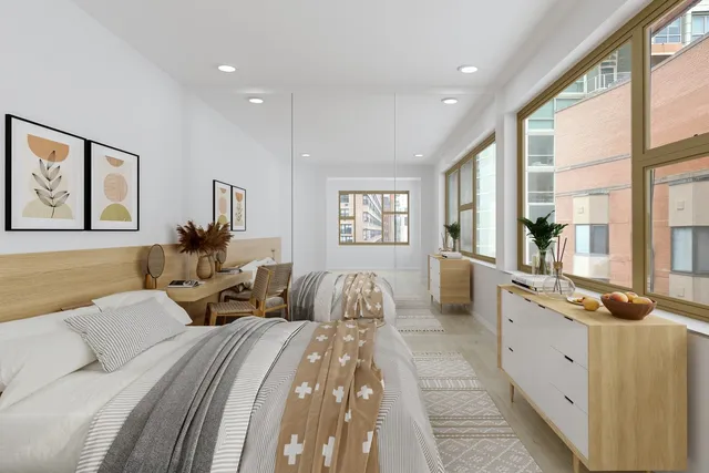 a bed room with large bed and windows