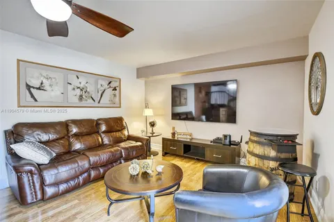 a view of a livingroom with furniture wooden floor and windows