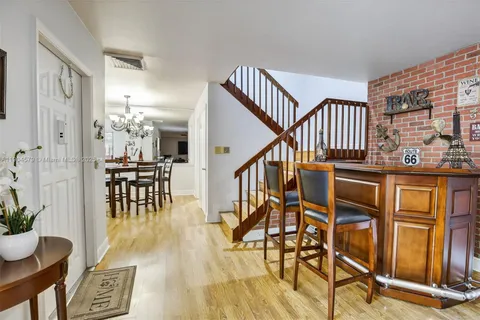 a kitchen with stainless steel appliances granite countertop a refrigerator a stove top oven a sink and dishwasher