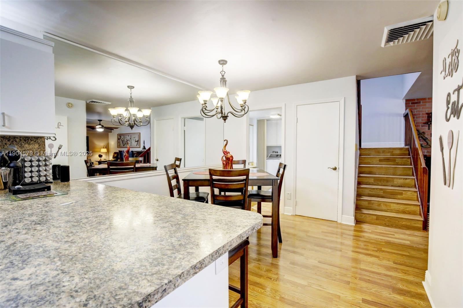 9927 Northwest 6th Place Plantation, FL 33324 - Photo 16 of 43 a view of a dining room with furniture and wooden floor