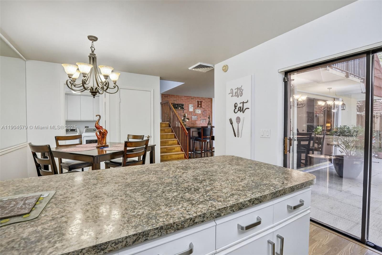 9927 Northwest 6th Place Plantation, FL 33324 - Photo 18 of 43 a dining hall with a dining table and a large window