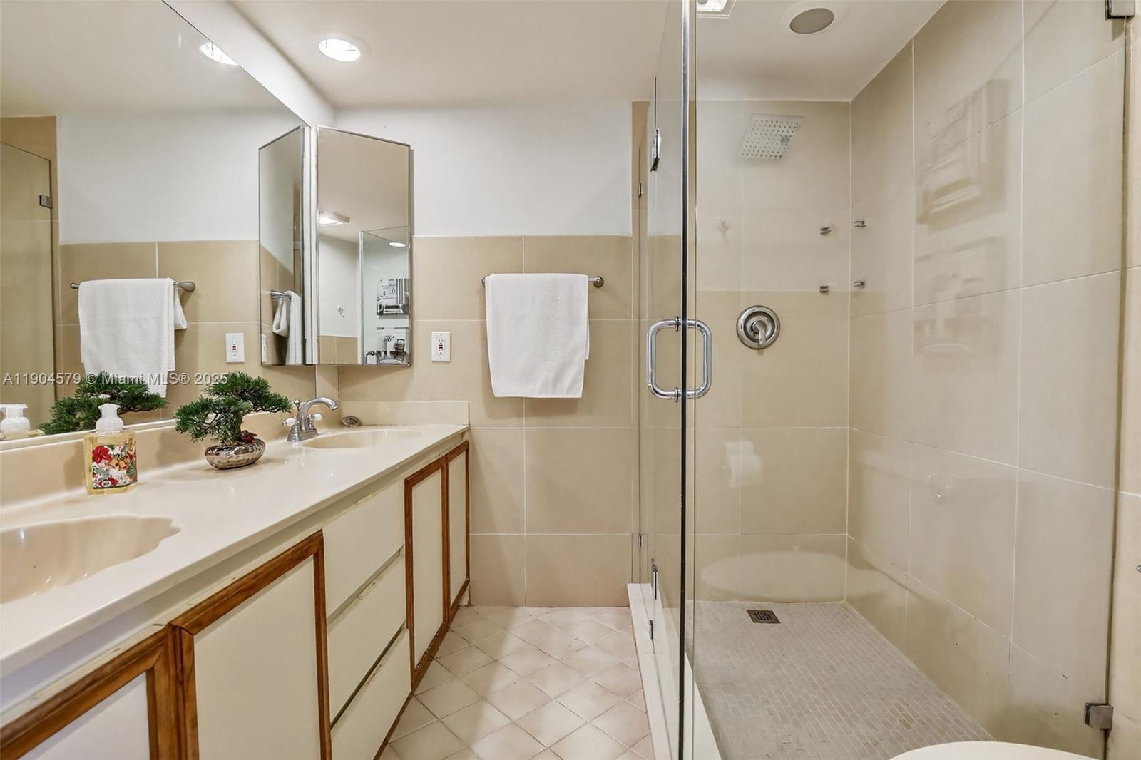 9927 Northwest 6th Place Plantation, FL 33324 - Photo 23 of 43 a bathroom with a double vanity sink mirror and shower