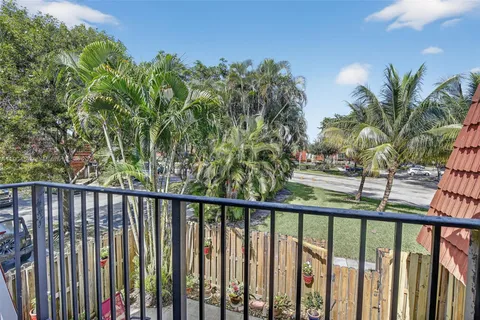 a view of a wooden fence and trees