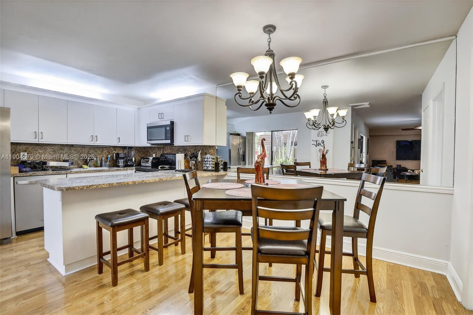 9927 Northwest 6th Place Plantation, FL 33324 - Photo 6 of 43 a view of a dining room with furniture and wooden floor