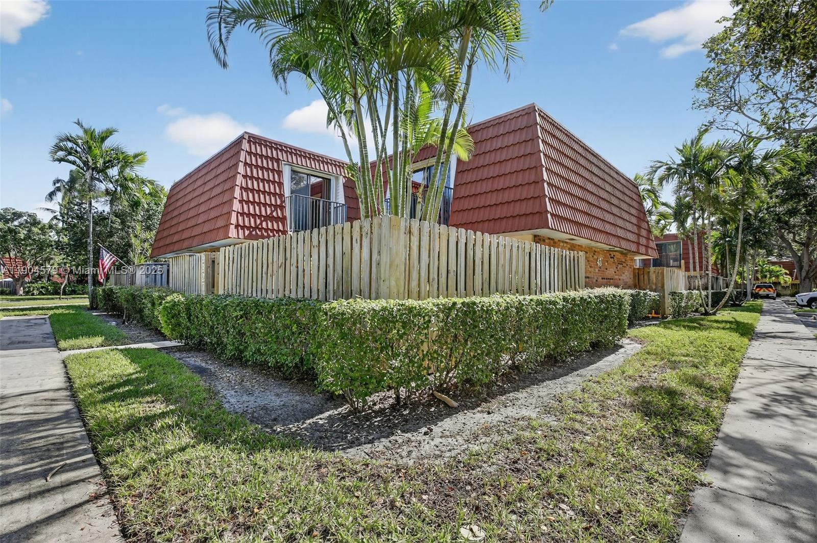 9927 Northwest 6th Place Plantation, FL 33324 - Photo 10 of 43 a front view of a house with a yard and potted plants