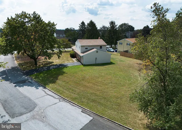 an aerial view of a house with a yard