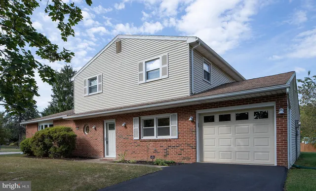 a view of brick house with large windows