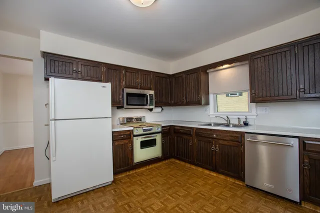 a kitchen with a sink cabinets and window
