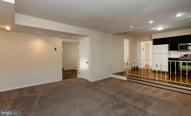 a view of a room with wooden floor and exposed radiator