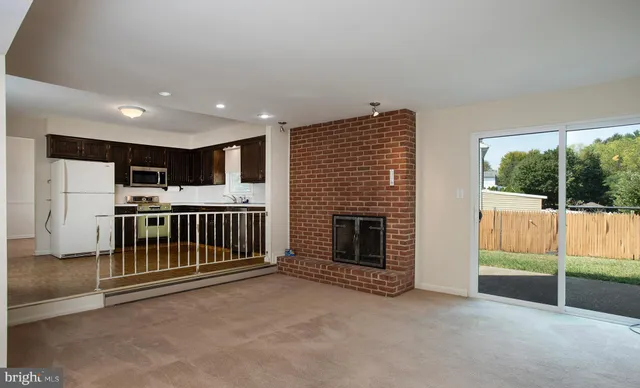 a view of a room with wooden floor chandelier and a window