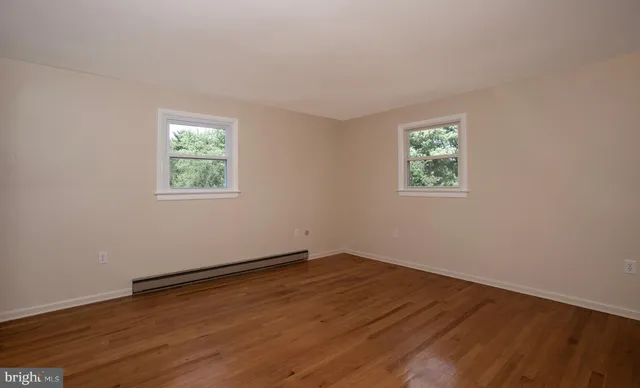 a bathroom with a granite countertop sink a toilet and a mirror