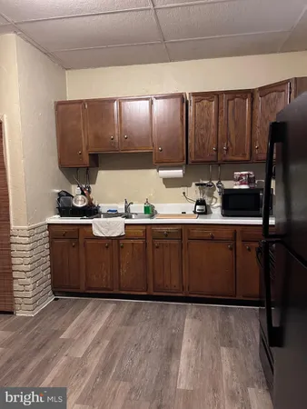 a view of a hallway with kitchen and entryway