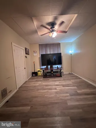 a bedroom with a bed and a view of kitchen