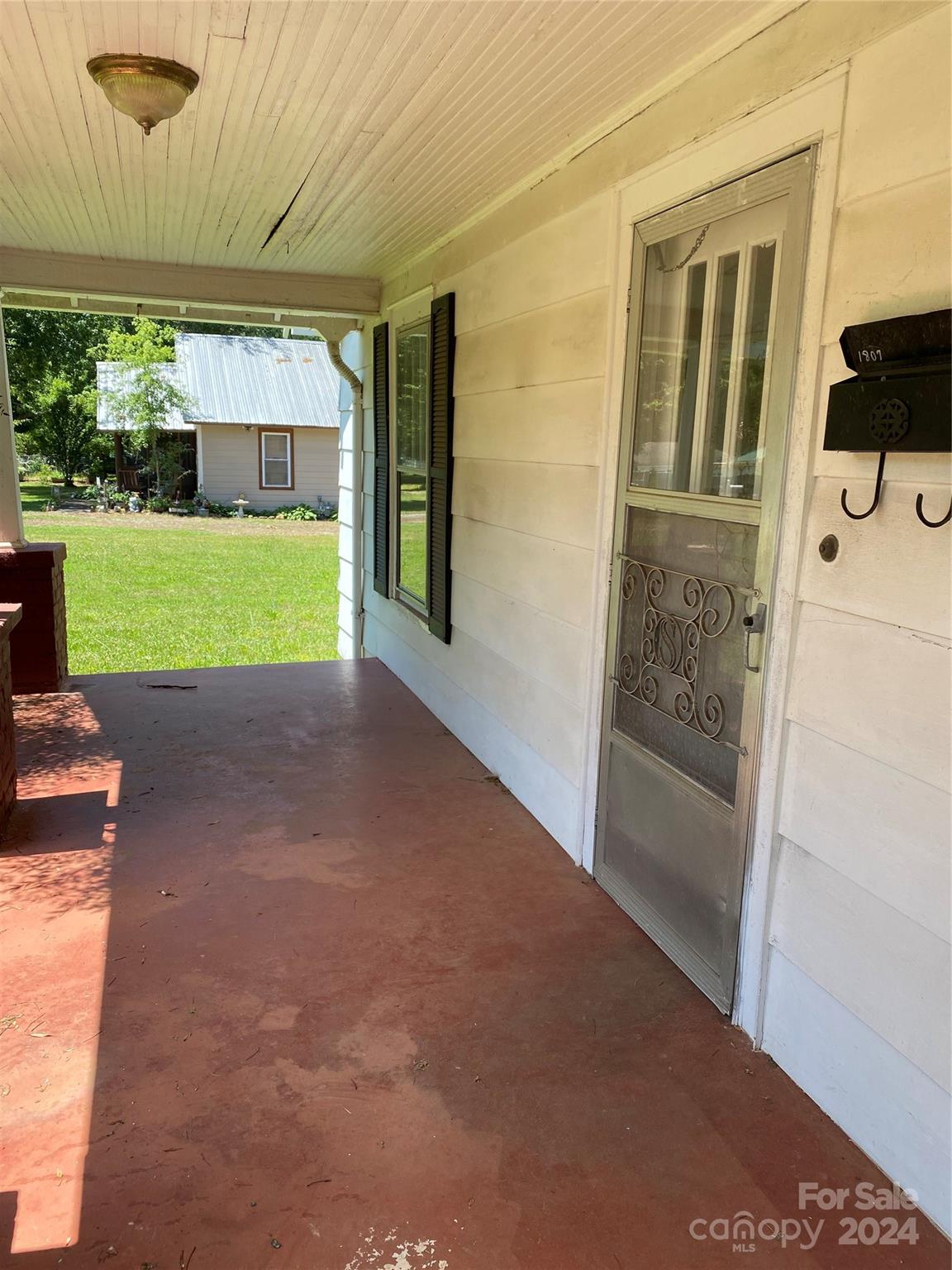 771 Spindale Street Spindale, NC 28160 - Photo 2 of 14 a view of a house with a big yard and potted plants