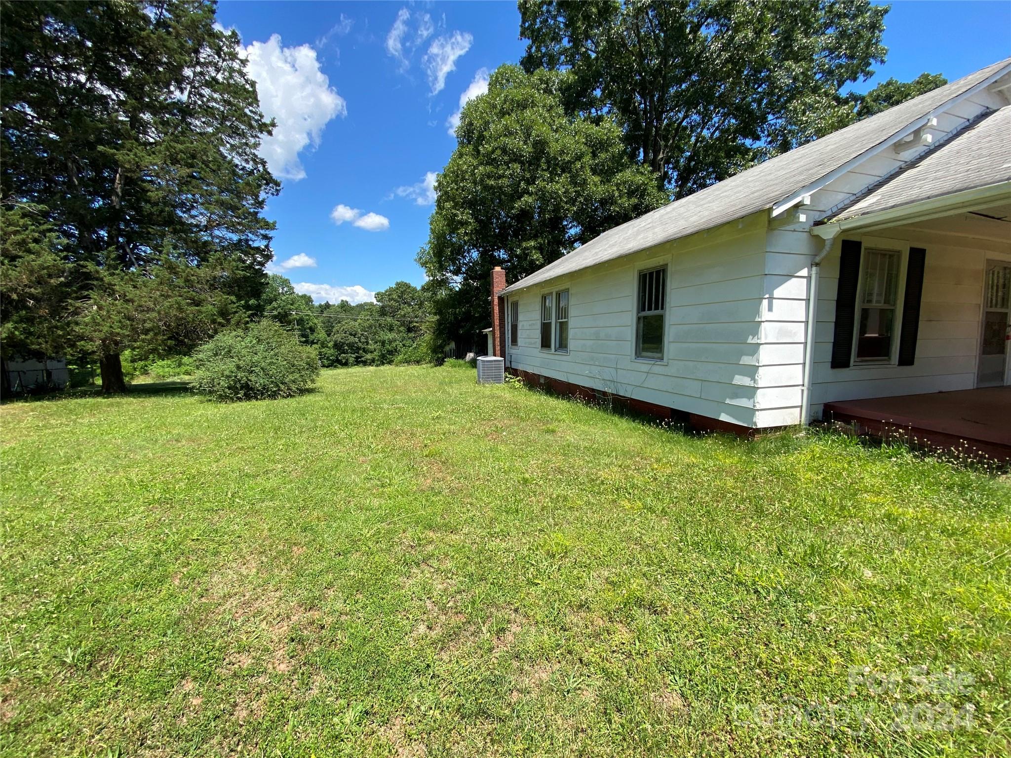 771 Spindale Street Spindale, NC 28160 - Photo 3 of 14 a view of a backyard with plants and large tree