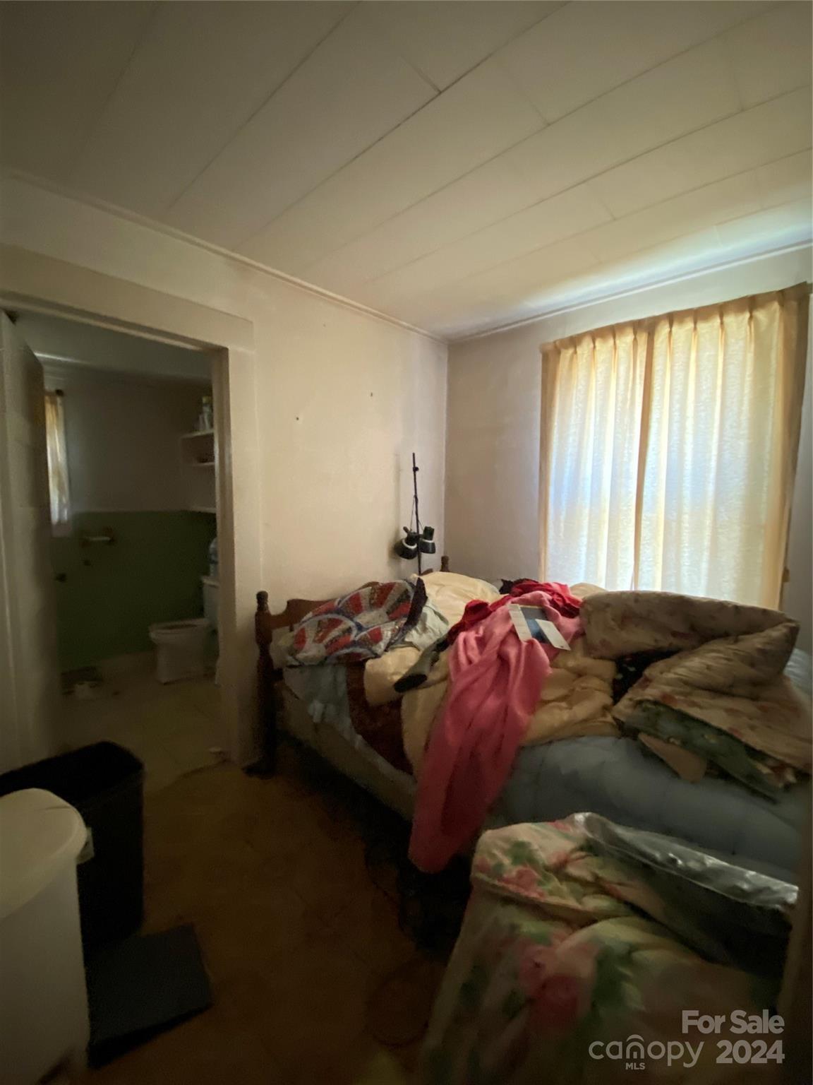 771 Spindale Street Spindale, NC 28160 - Photo 6 of 14 a bed sitting in a bedroom next to a window and a chair