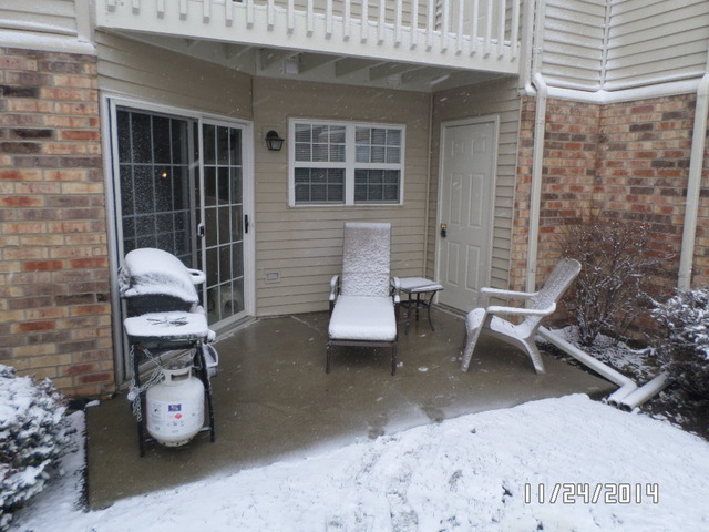 1490 Spring Brook Court, Unit 1G Round Lake Beach, IL 60073 - Photo 2 of 12 a building outdoor space with patio furniture