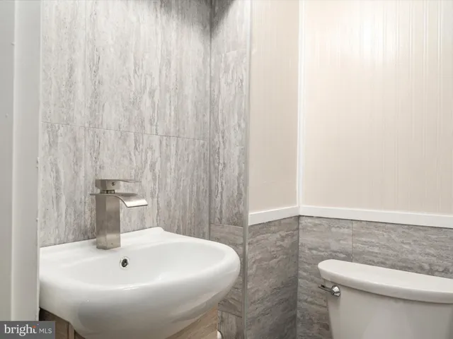 a view of a hallway with white walls and entryway