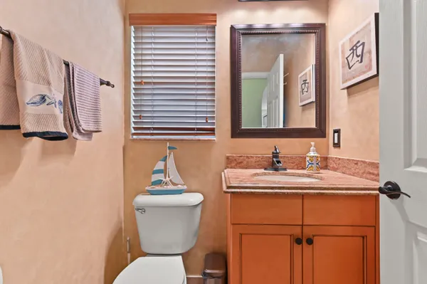 a bathroom with a sink a toilet and mirror