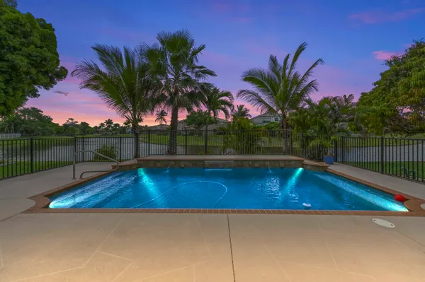 a view of swimming pool with a table and chair