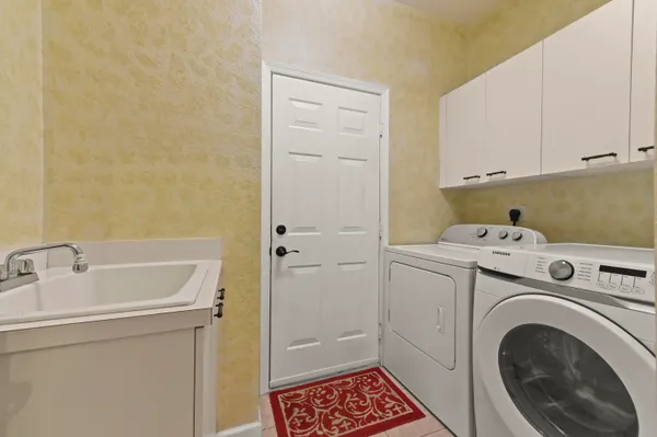 a bathroom with a sink and a washer dryer