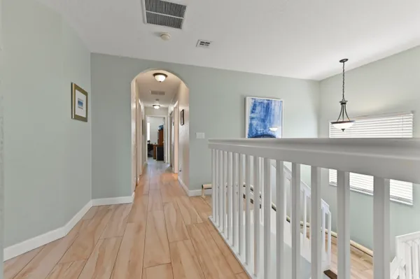 a view of a hallway view with wooden floor and staircase