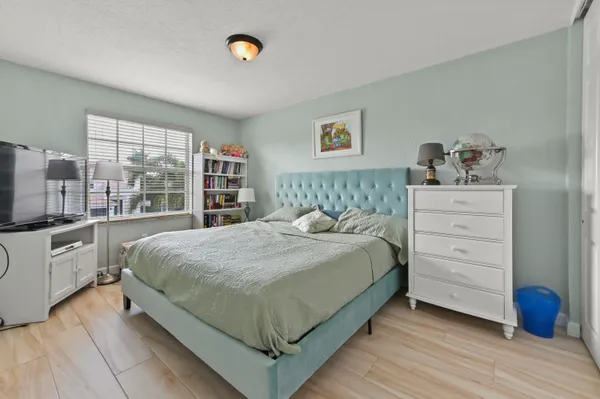 a bedroom with a large bed and a window