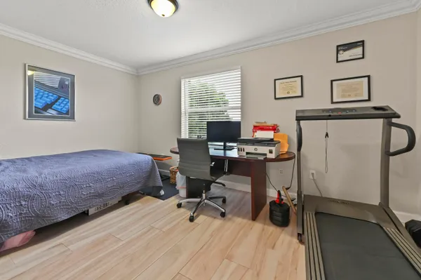 a bedroom with a bed and a desk