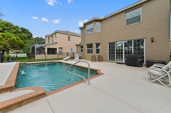 a view of a house with backyard sitting area and garden